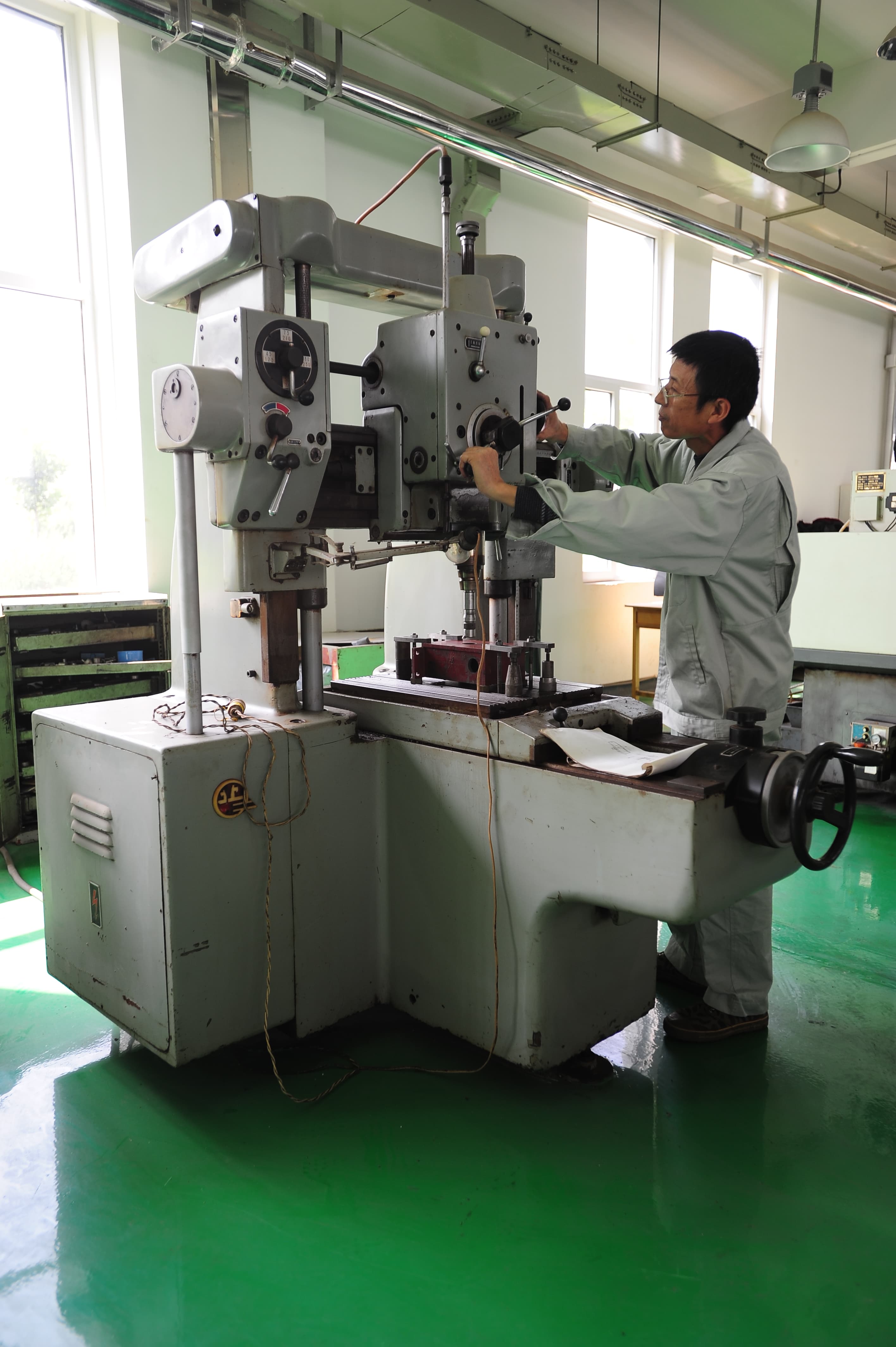 Technician operating fabrication equipment.