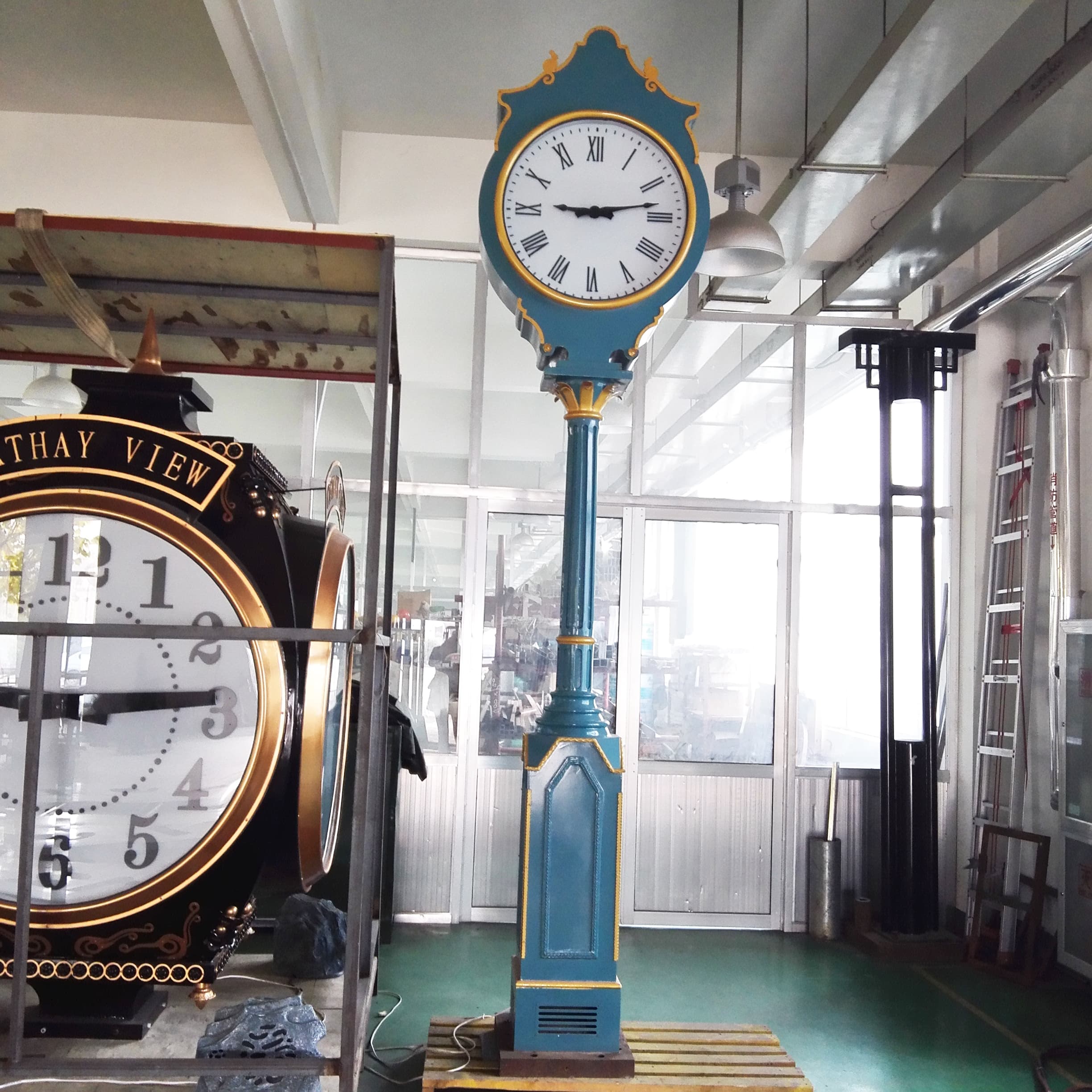 Decorative blue street clock displayed in an interior showroom.