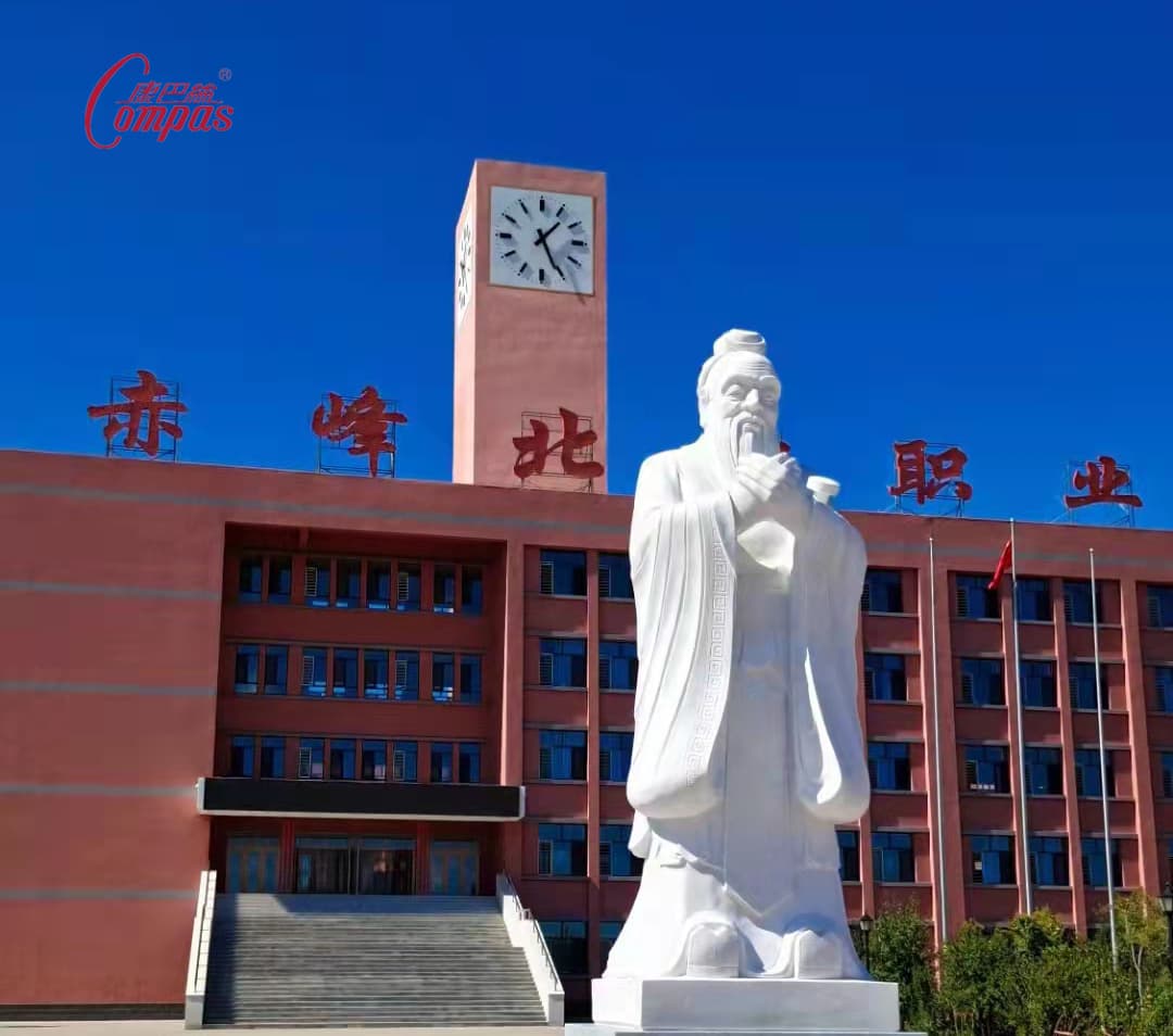 Four-sided tower clock at a school campus.