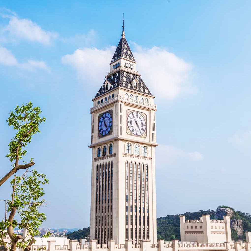Tall landmark tower with multiple clock faces.