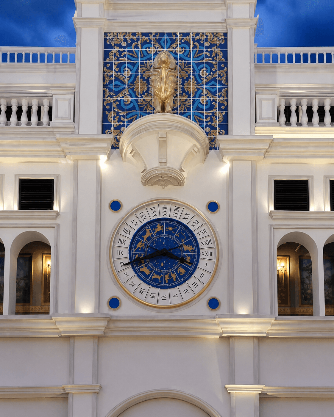 Illuminated astronomical clock integrated into an architectural façade in Nigeria.
