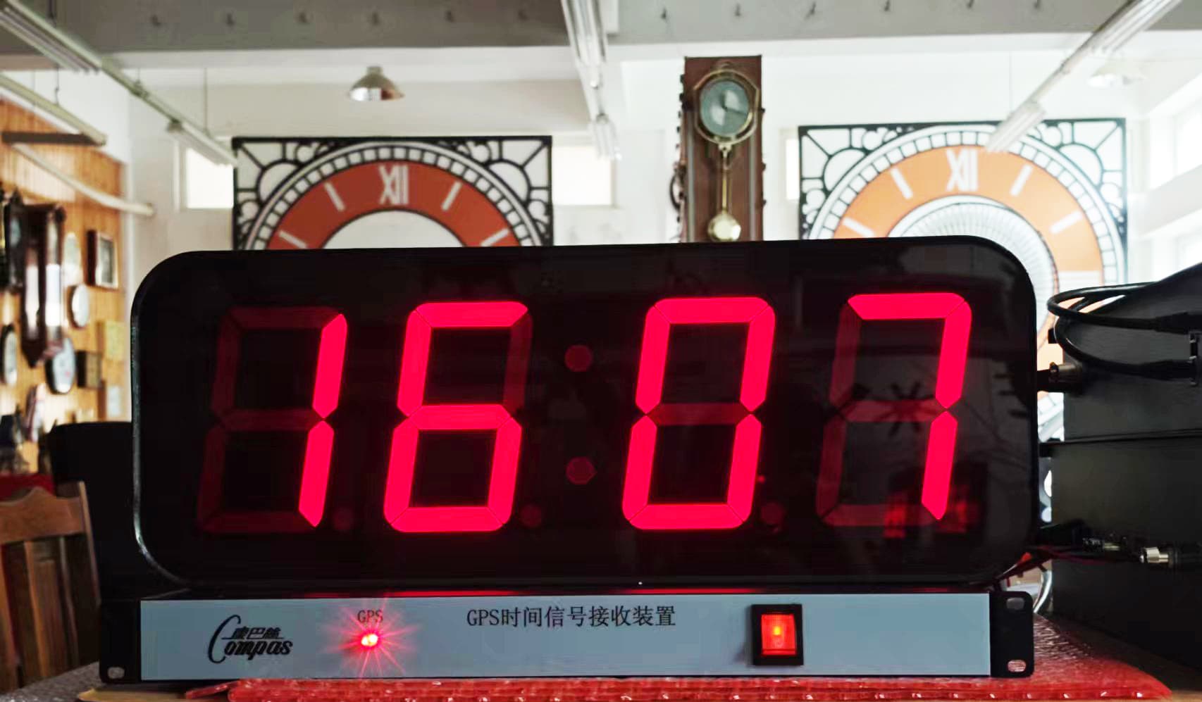 GPS-synchronised digital clock shown in a product display area.