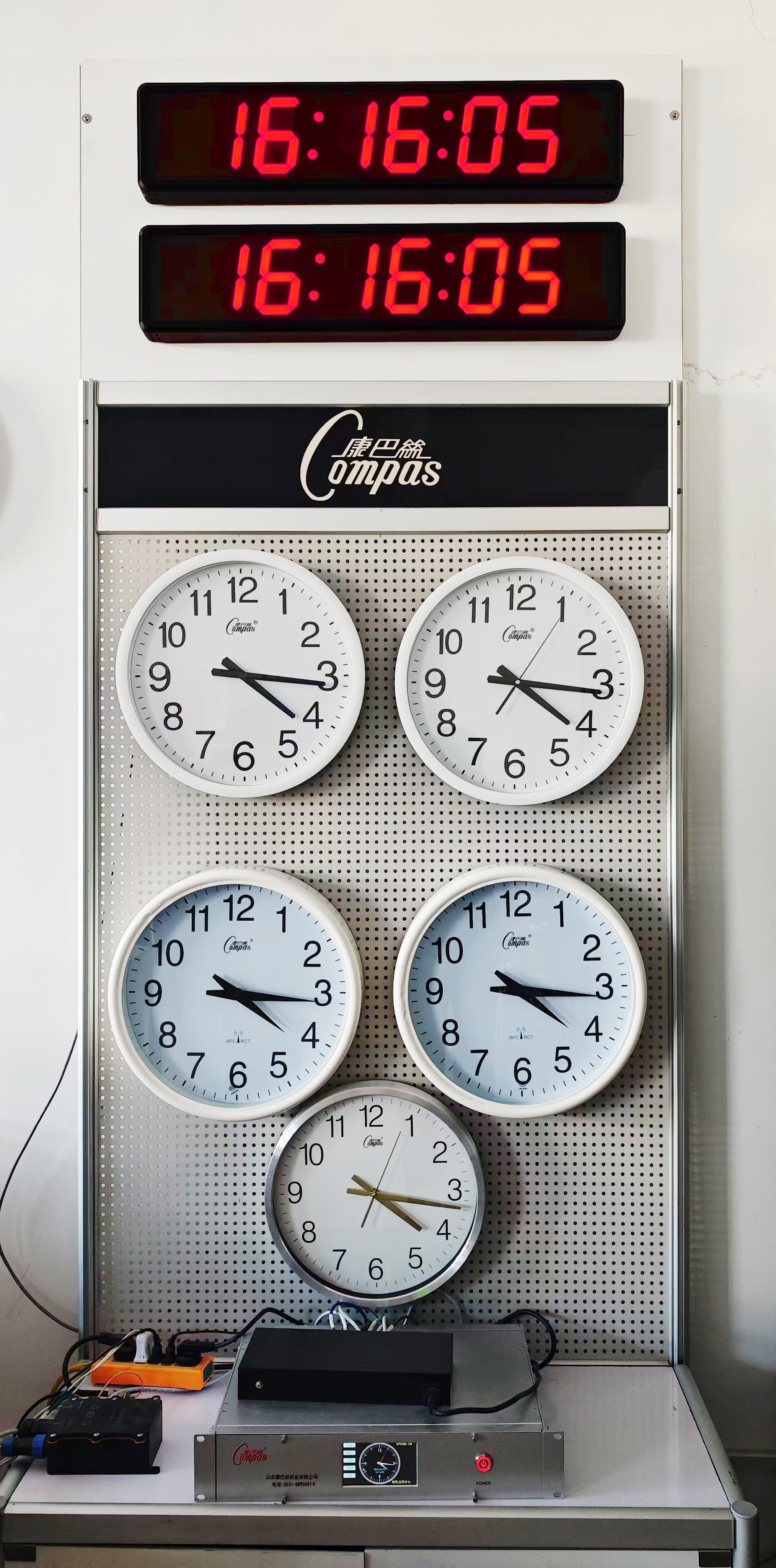 Synchronized digital and analog clocks mounted together.