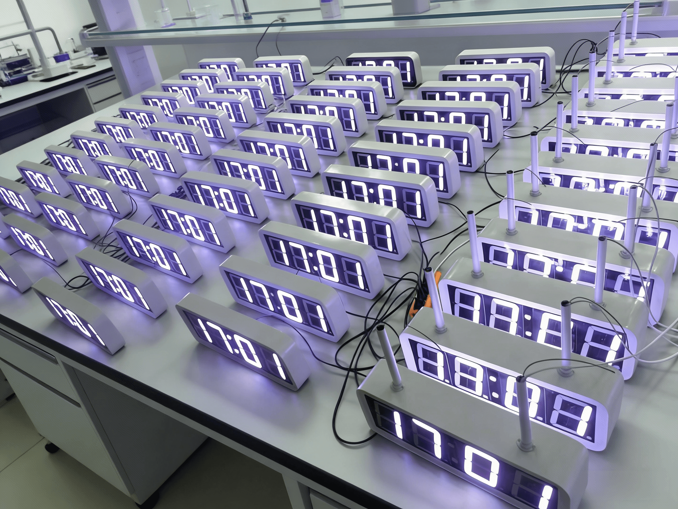 Multiple digital clocks undergoing synchronized testing.